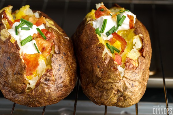 Fully loaded potatoes on a toaster oven rack