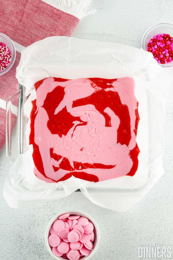 add pink candy to the red candy in the baking dish
