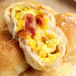 opened breakfast biscuit bite with egg, bacon and cheese inside.
