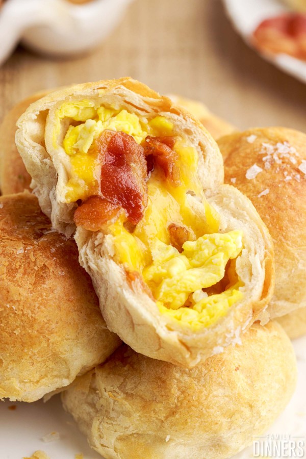 opened breakfast biscuit bite with egg, bacon and cheese inside.