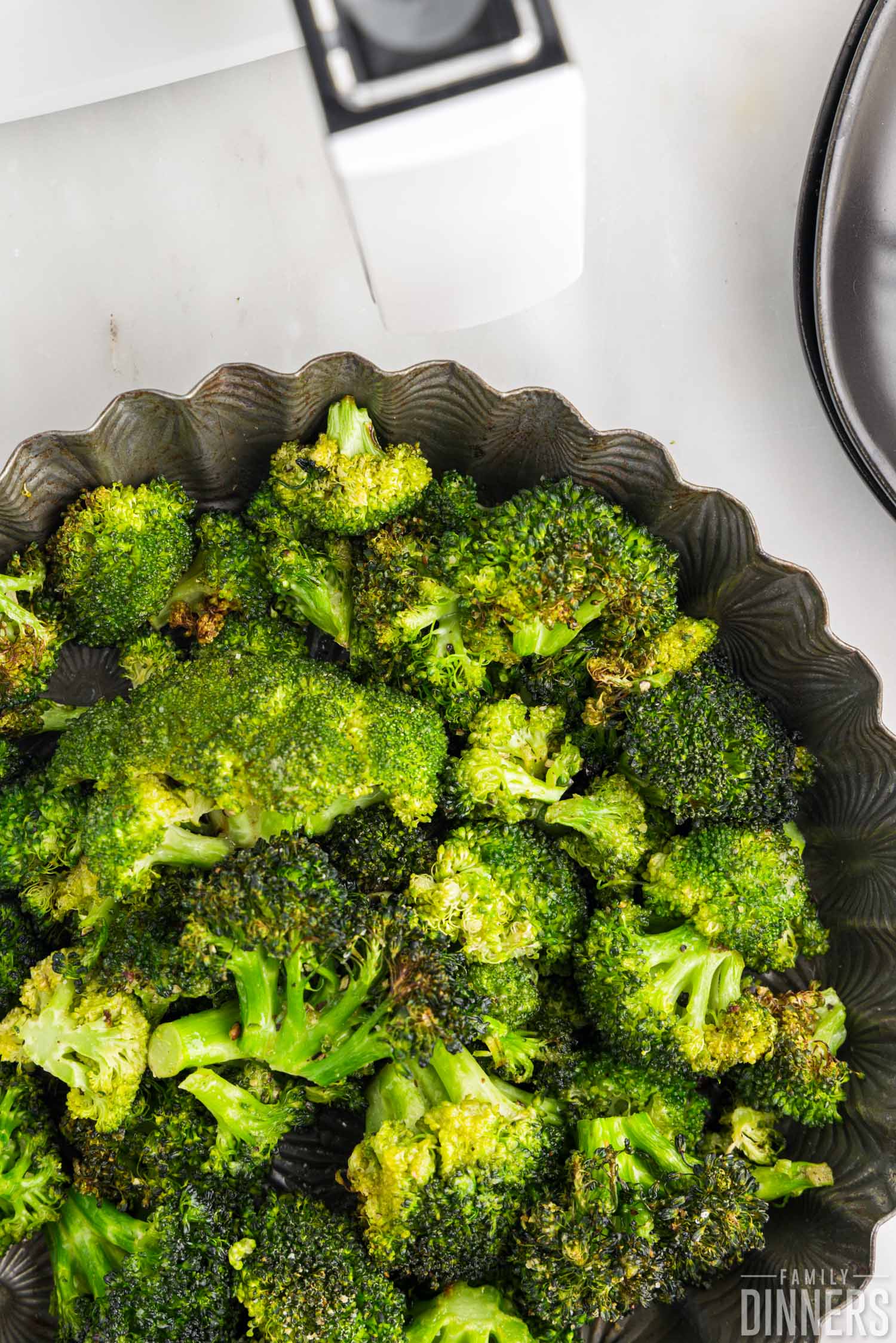 close up of bowl with air fried broccoli