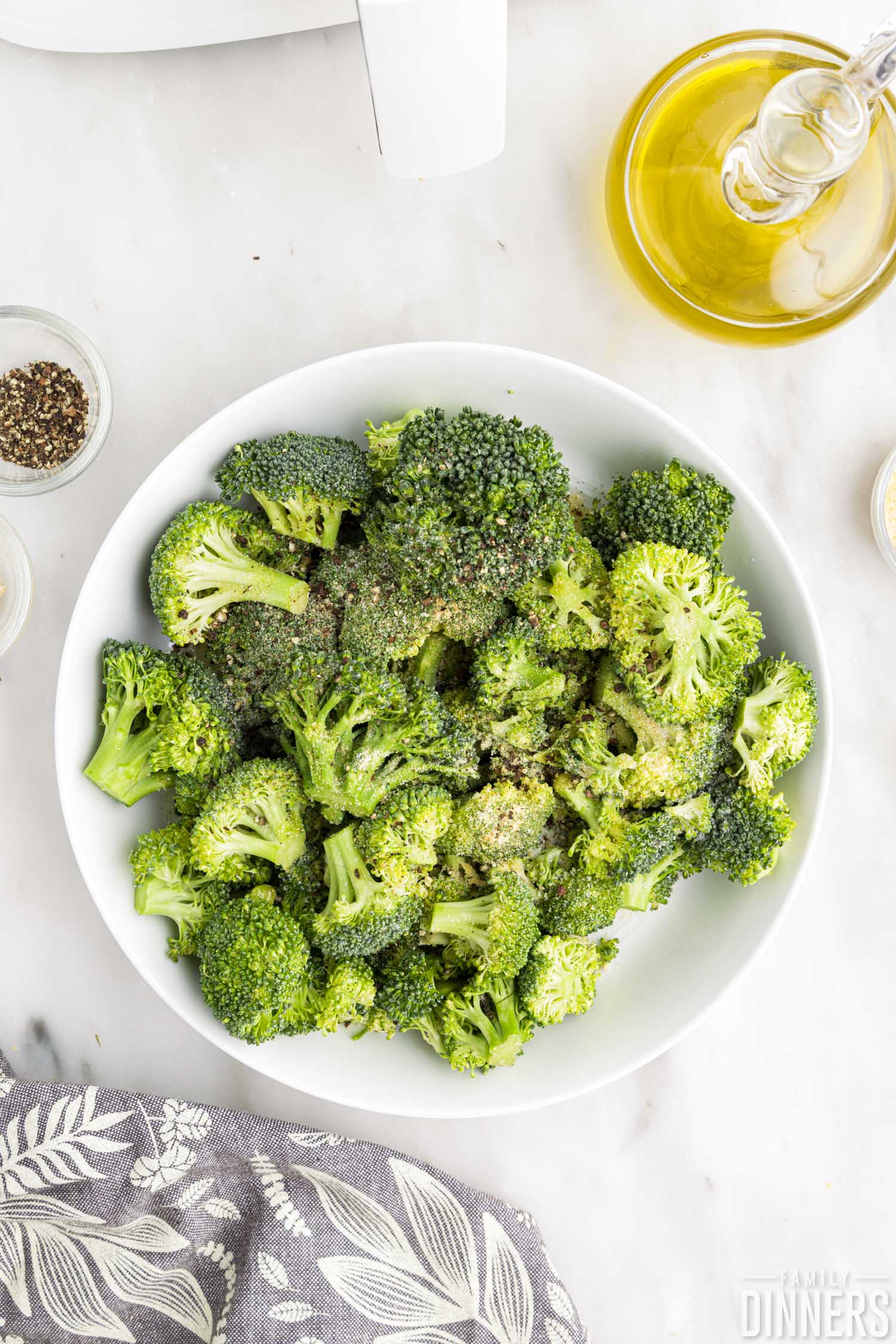 seasoning sprinkled over raw broccoli.