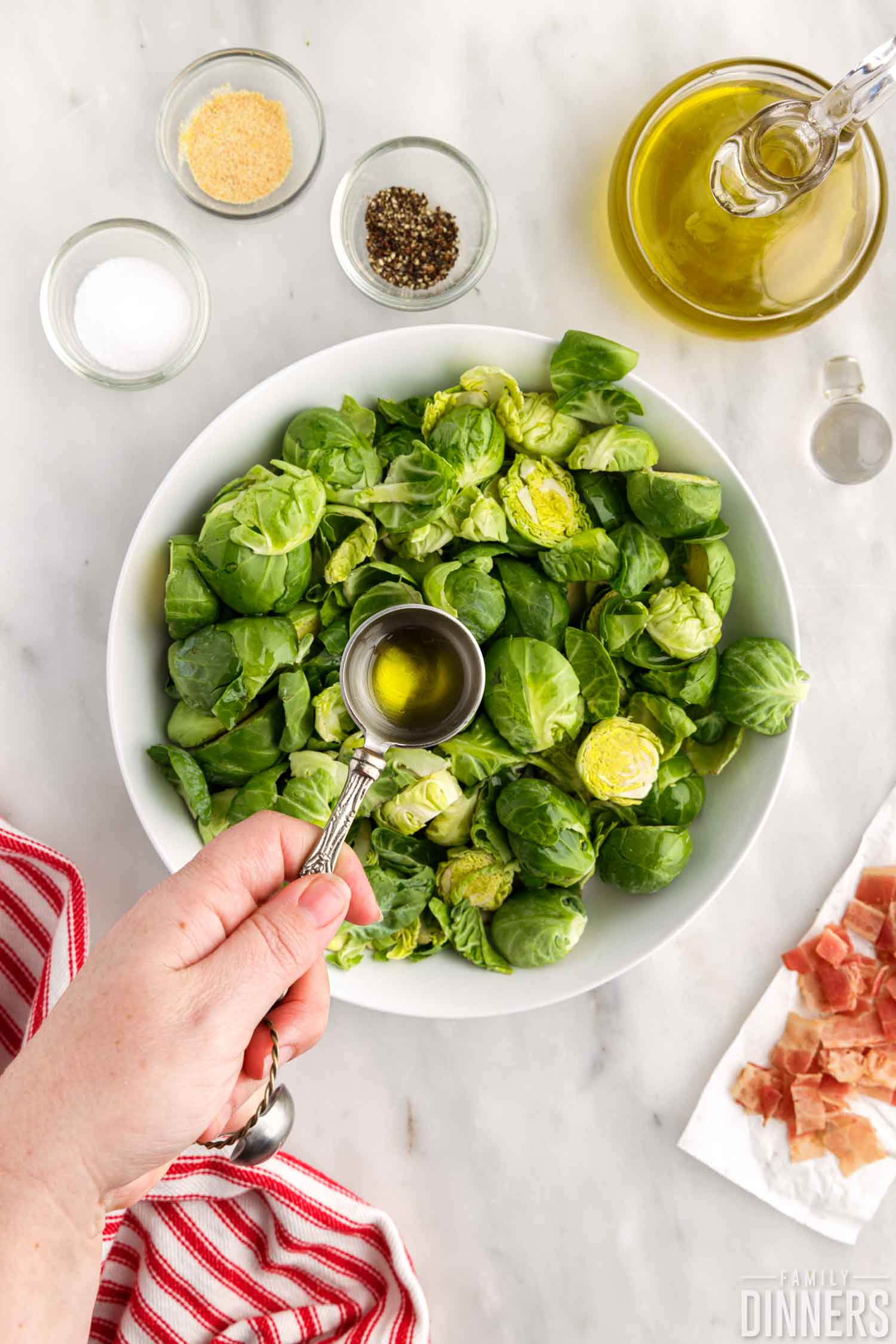 Oil poured over brussels sprouts.