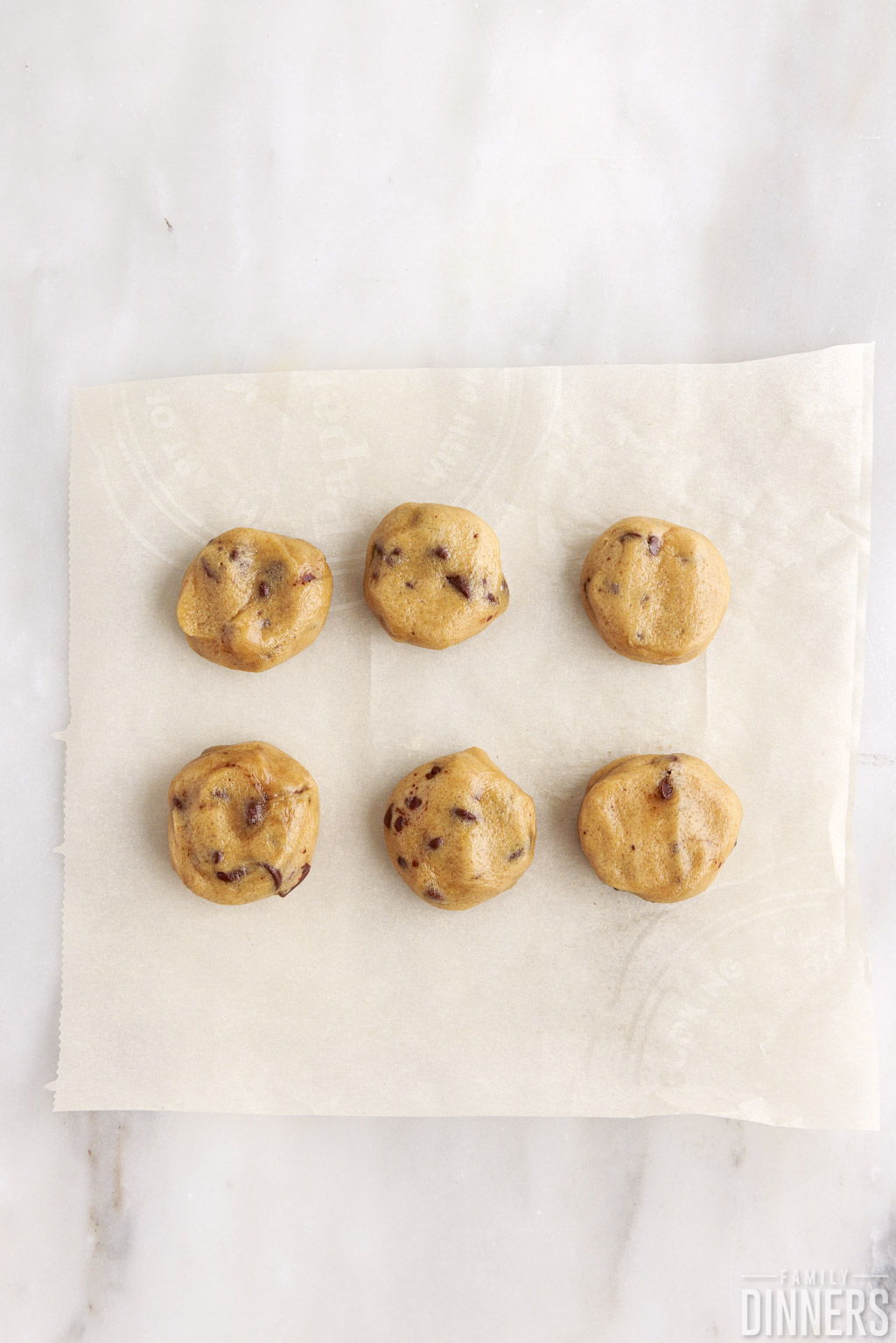 flattened cookie balls on parchment paper
