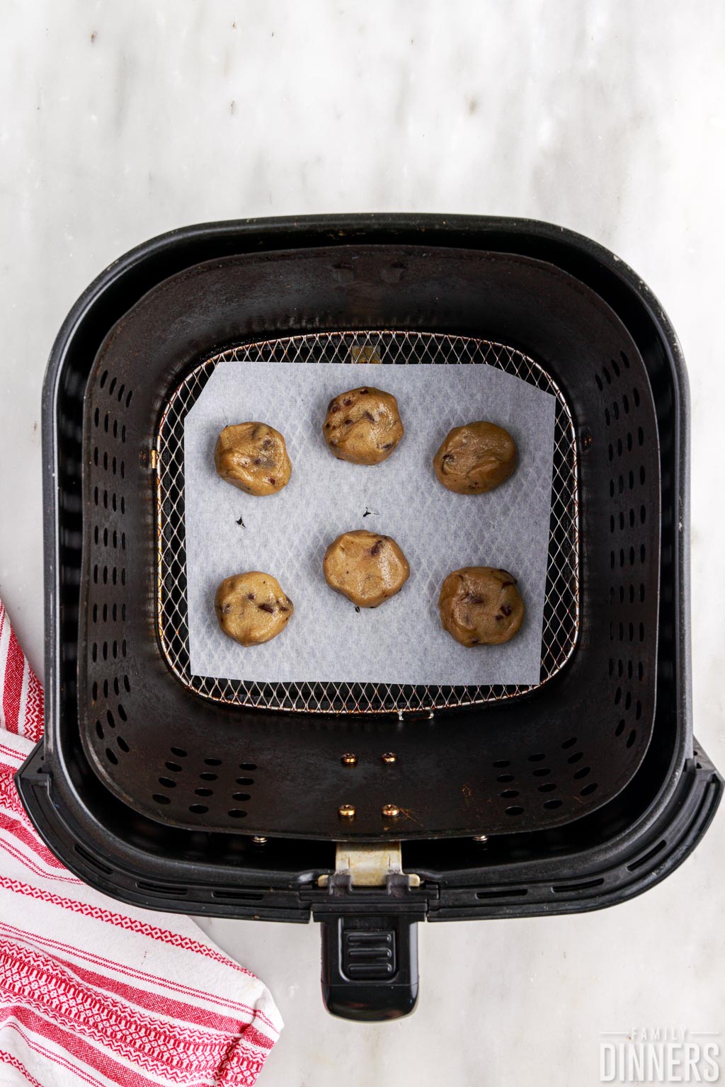 raw cookie dough on bottom of air fryer.