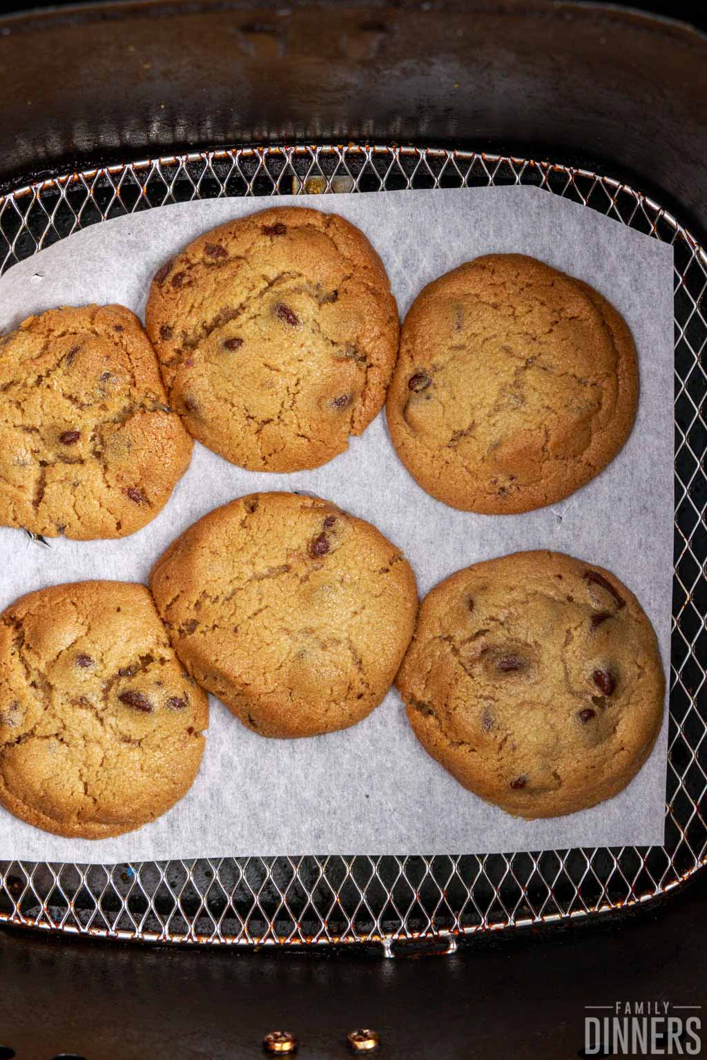 cooked cookies in air fryer basket.