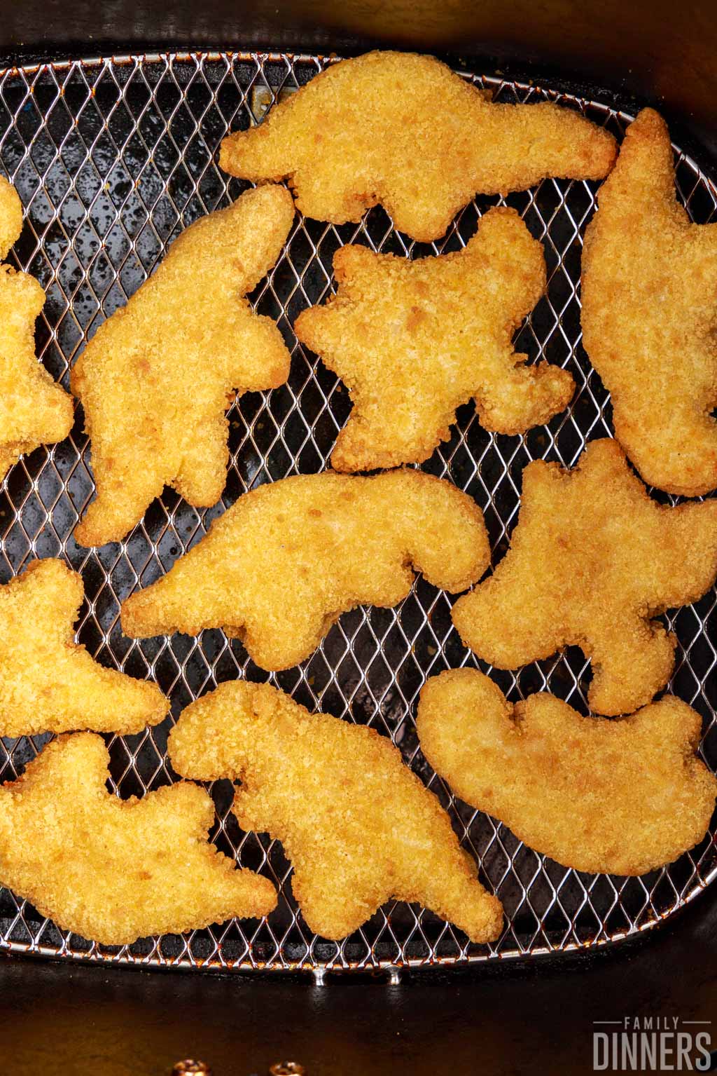 dino nuggets in air fryer basket.