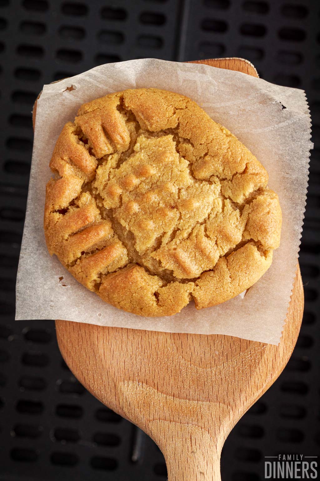 Large peanut butter cookie on a spatula.