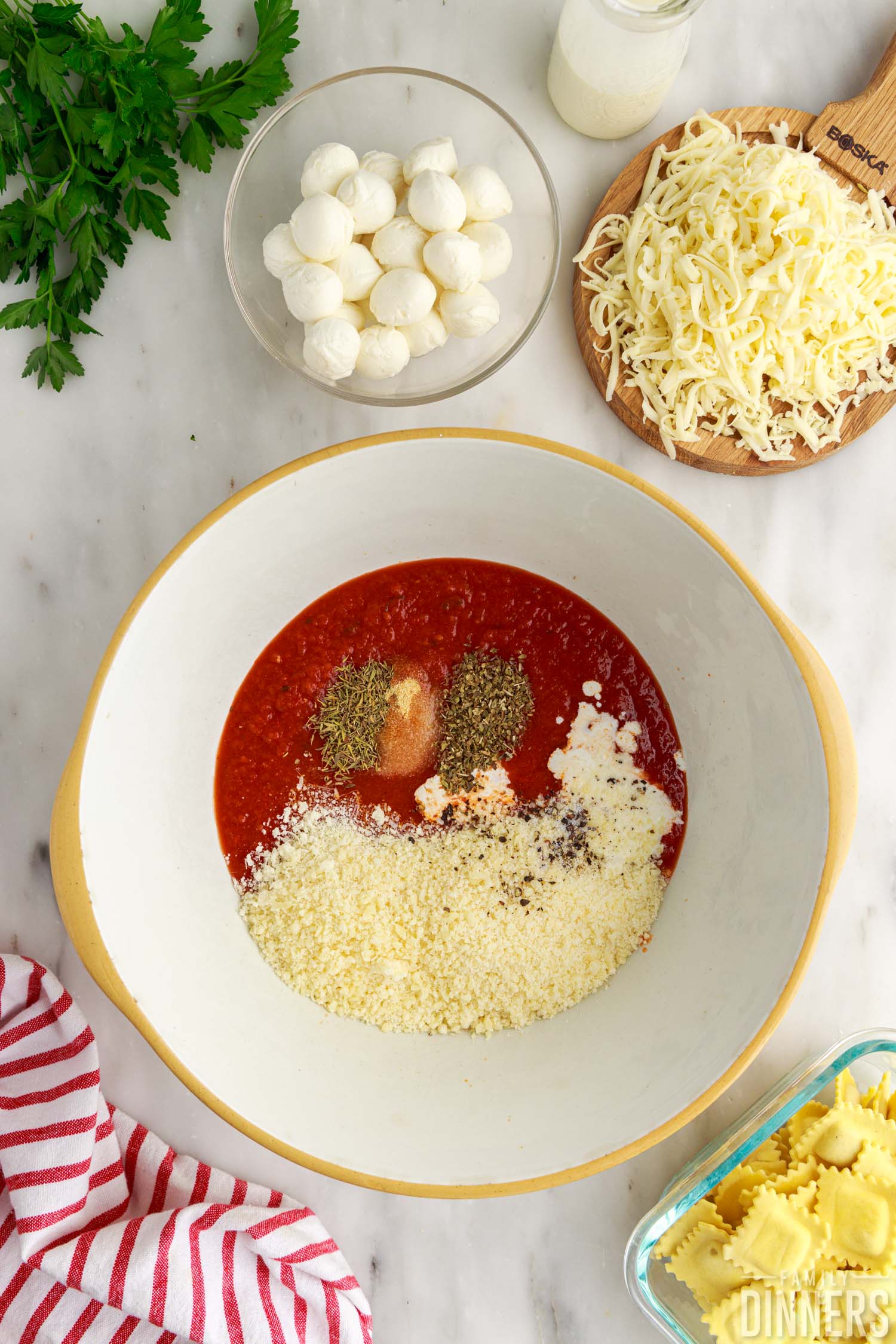 ingredients in a bowl for baked ravioli.