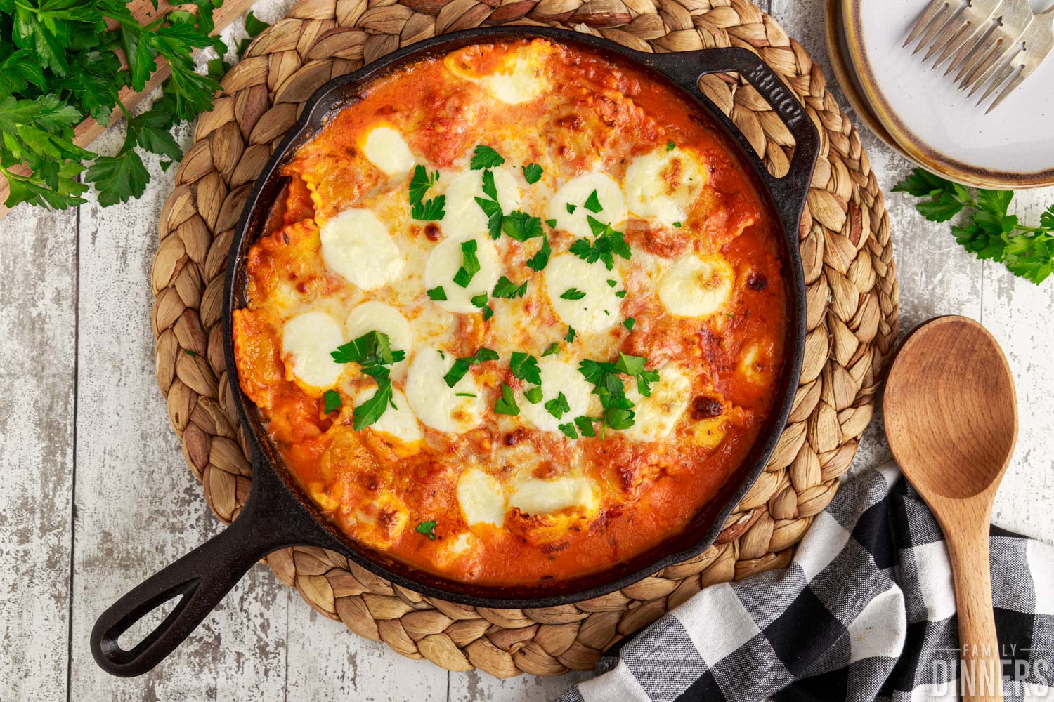 baked ravioli garnished with parsley and cheese