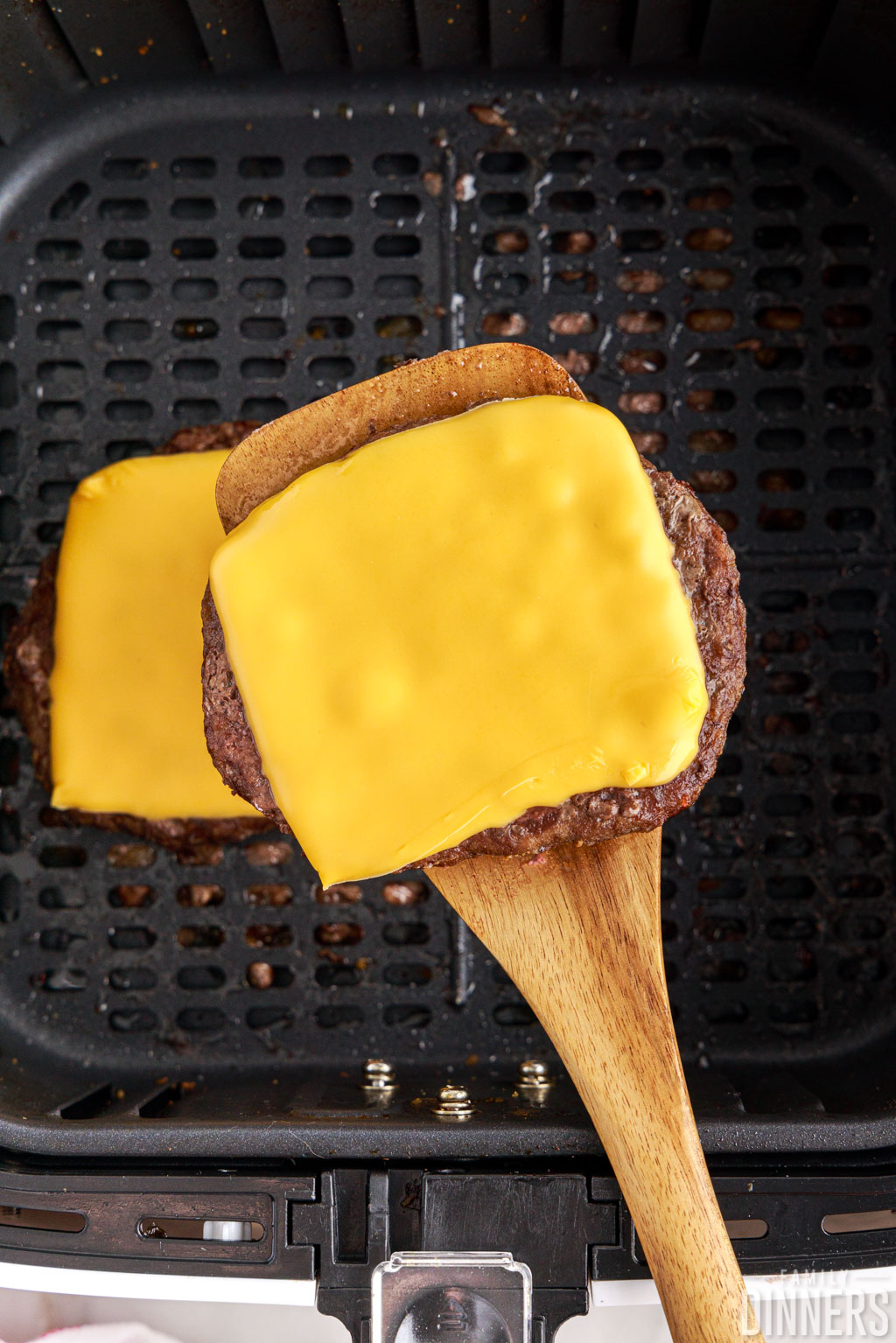 cheeseburger patty on a spatula.
