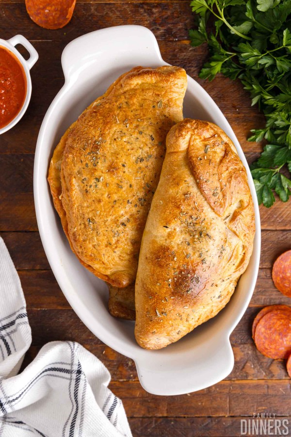 cooked calzones in dish.