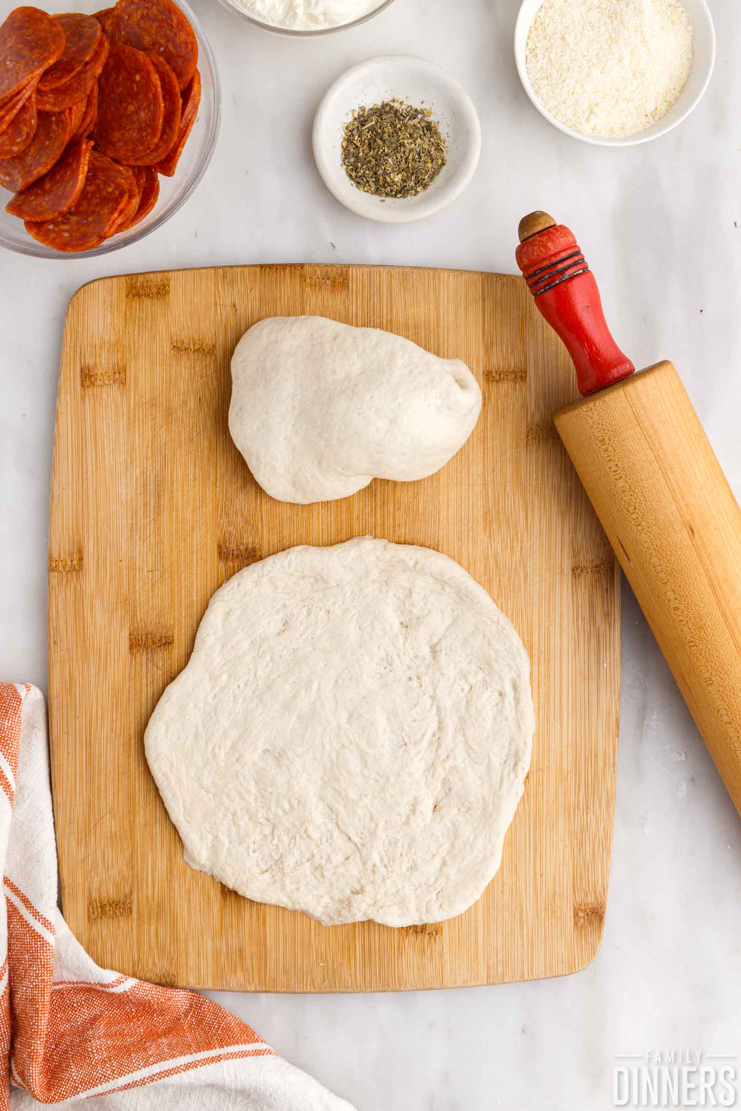 roll out pizza dough.