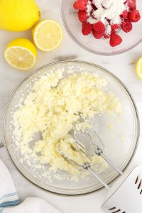Hand mixer beating sugar and butter together.