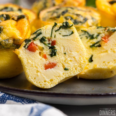 air fryer egg bites with spinach and red peppers.