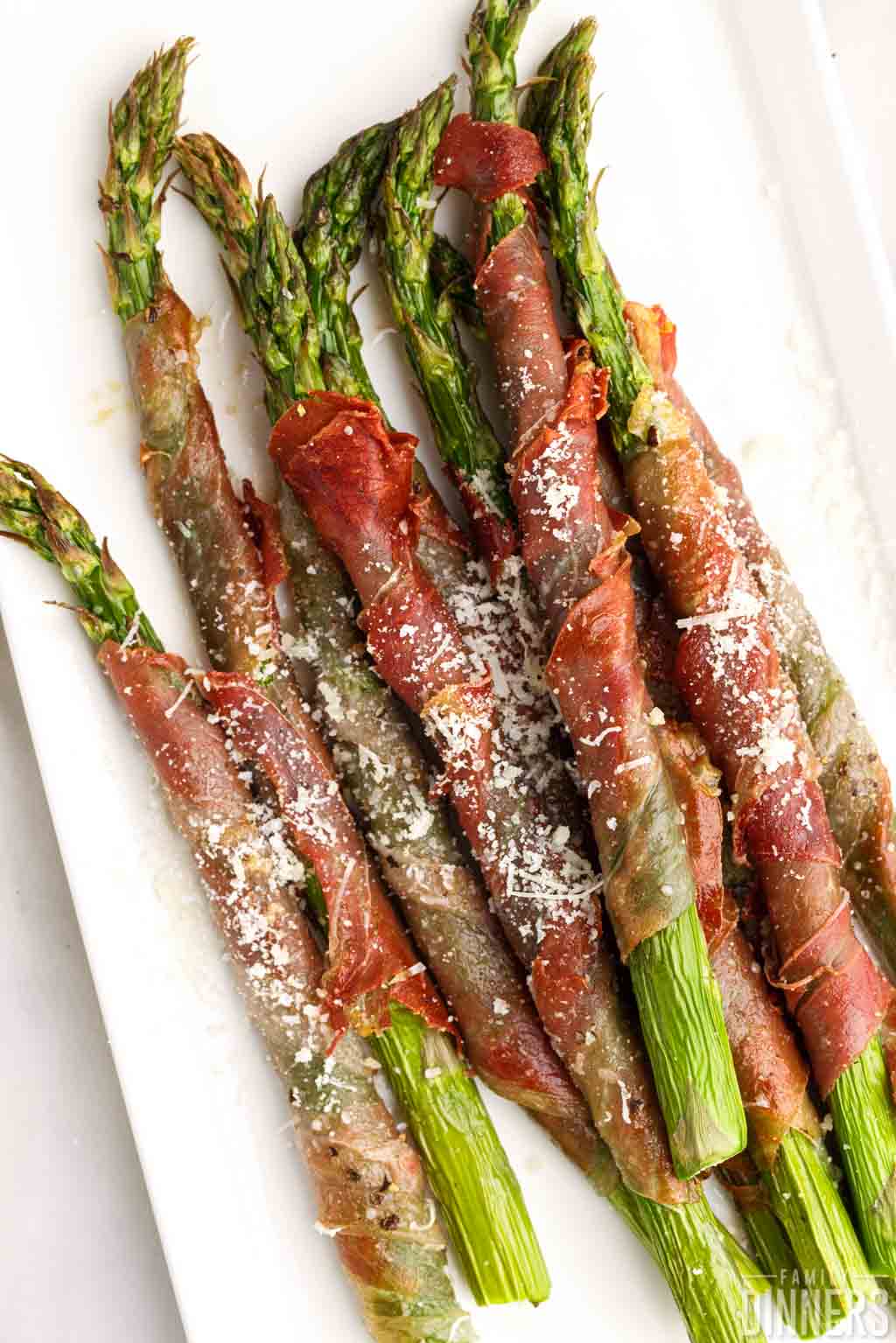 Cooked asparagus wrapped in prosciutto.