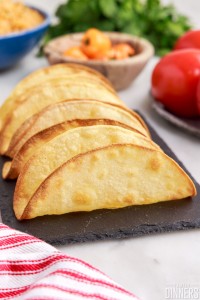 air fryer taco shells standing up on a tray.