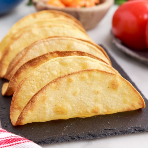 air fryer taco shells standing up on a tray.