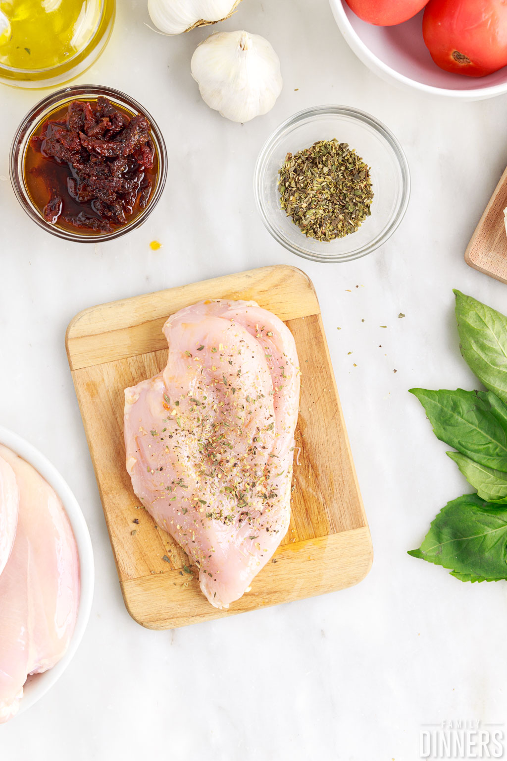 Oil and spices rubbed onto chicken breast.
