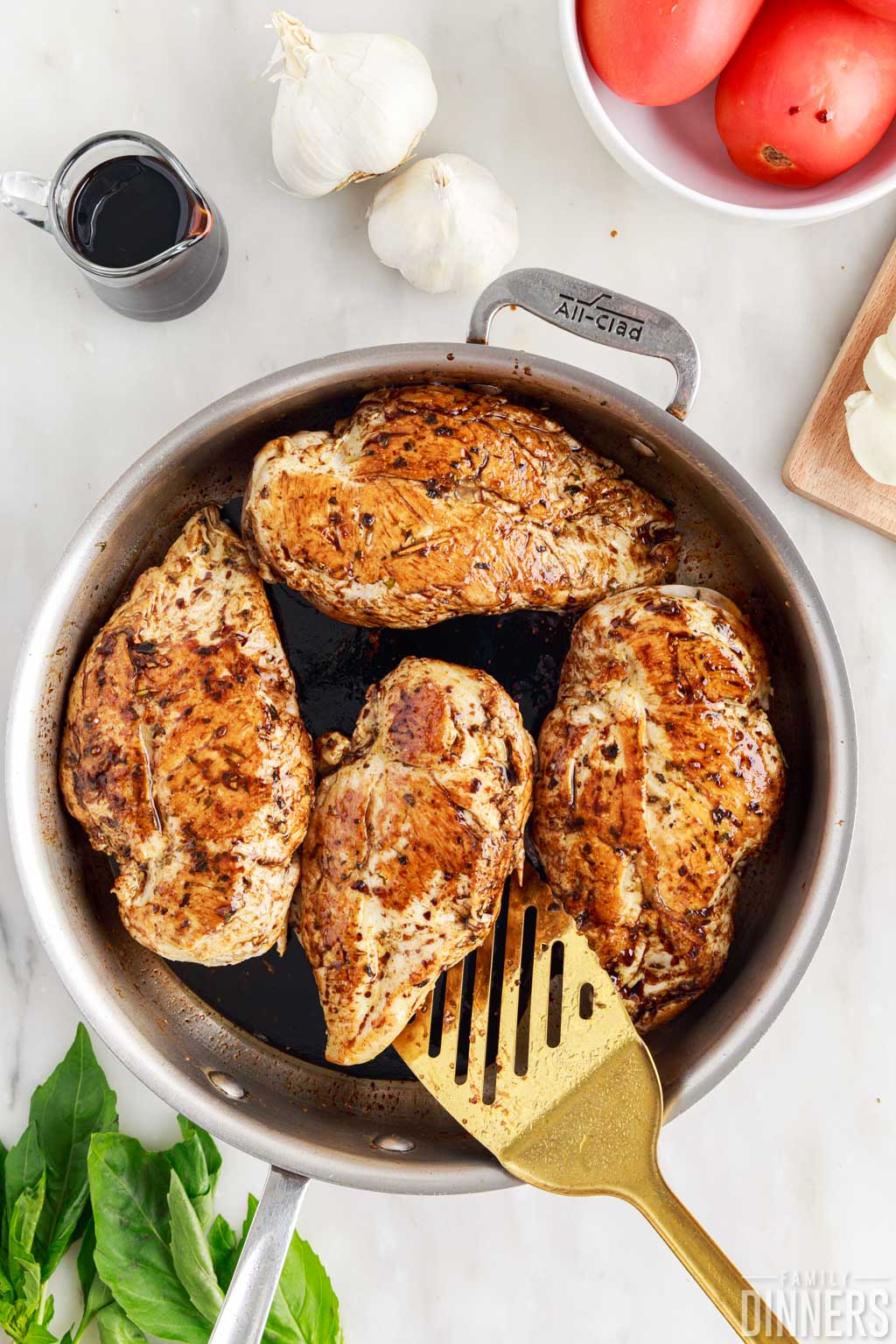 Chicken with balsamic glaze over top in skillet.