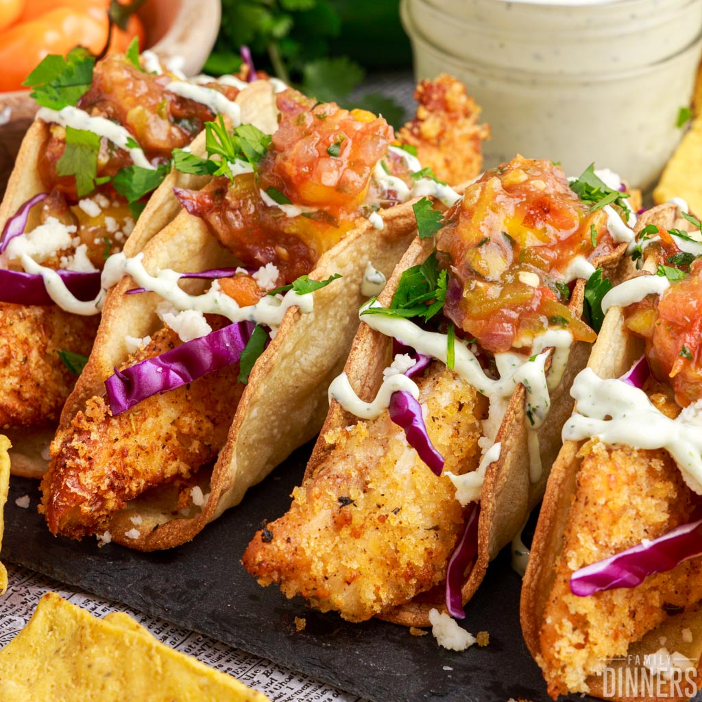 Fried fish tacos on crunchy taco shells.