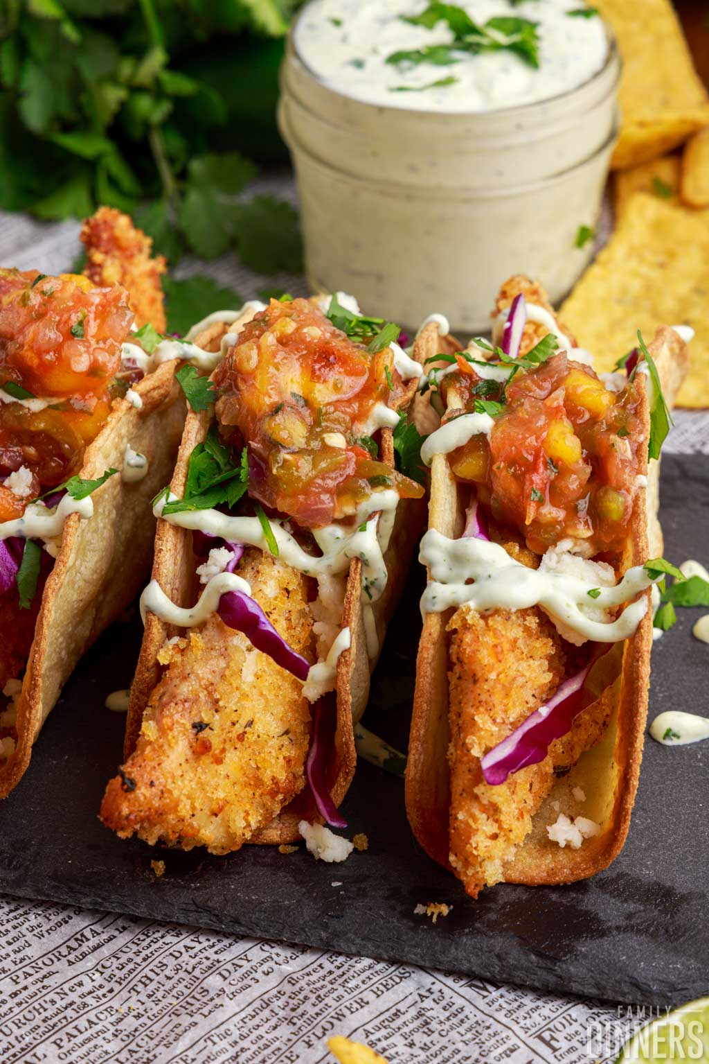 air fryer fish tacos lined up on a plate.