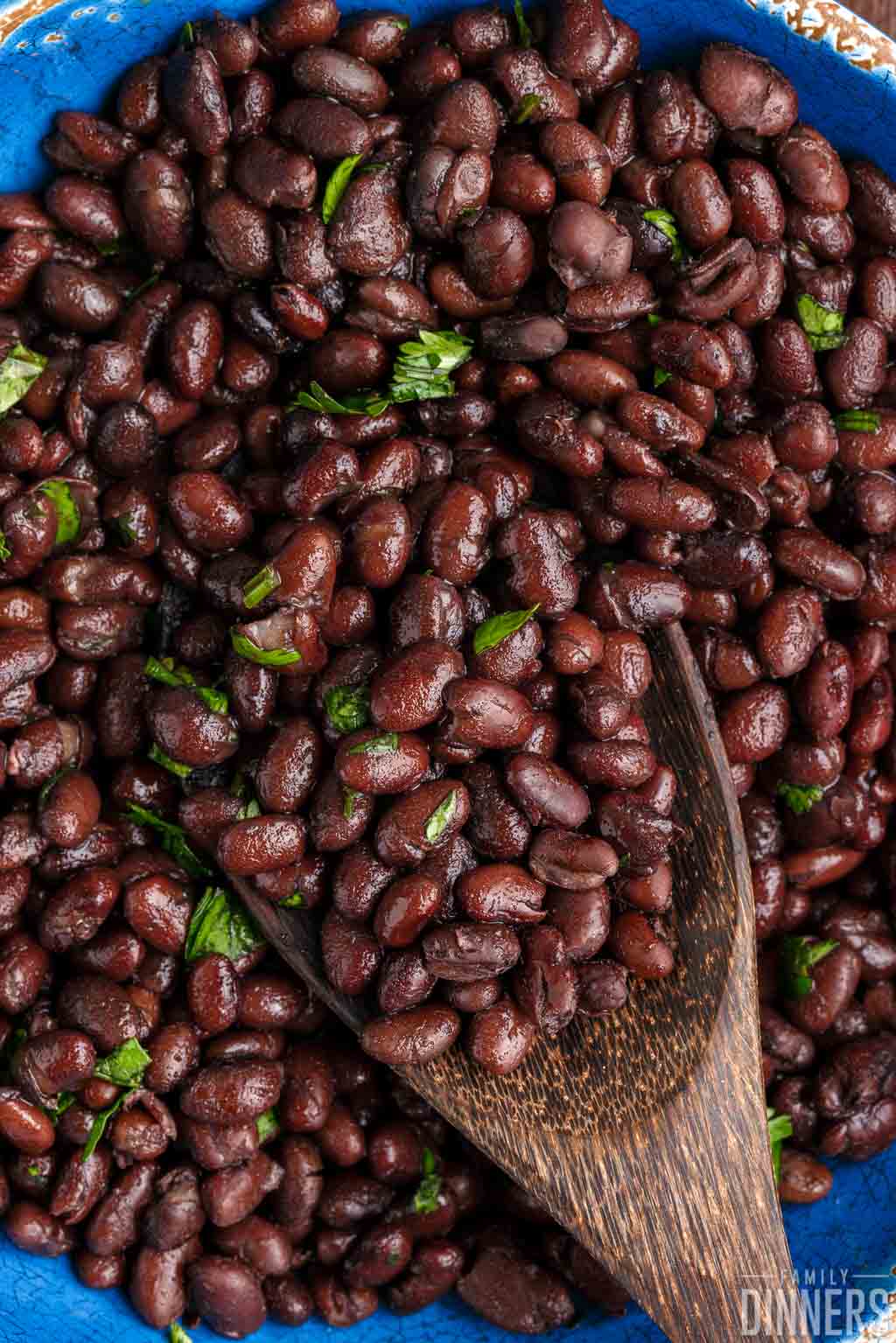 closeup of cooked black beans in a bowl.