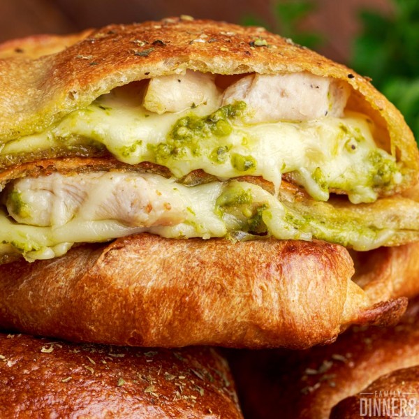 Pesto chicken calzone with cheese oozing out.