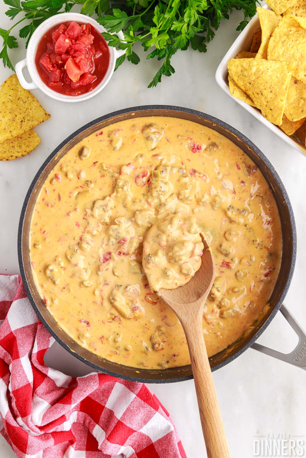 skillet full of melted rotel dip with sausage