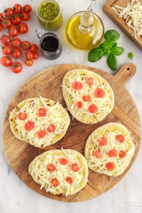 tomatoes and cheese on naan pizza crust