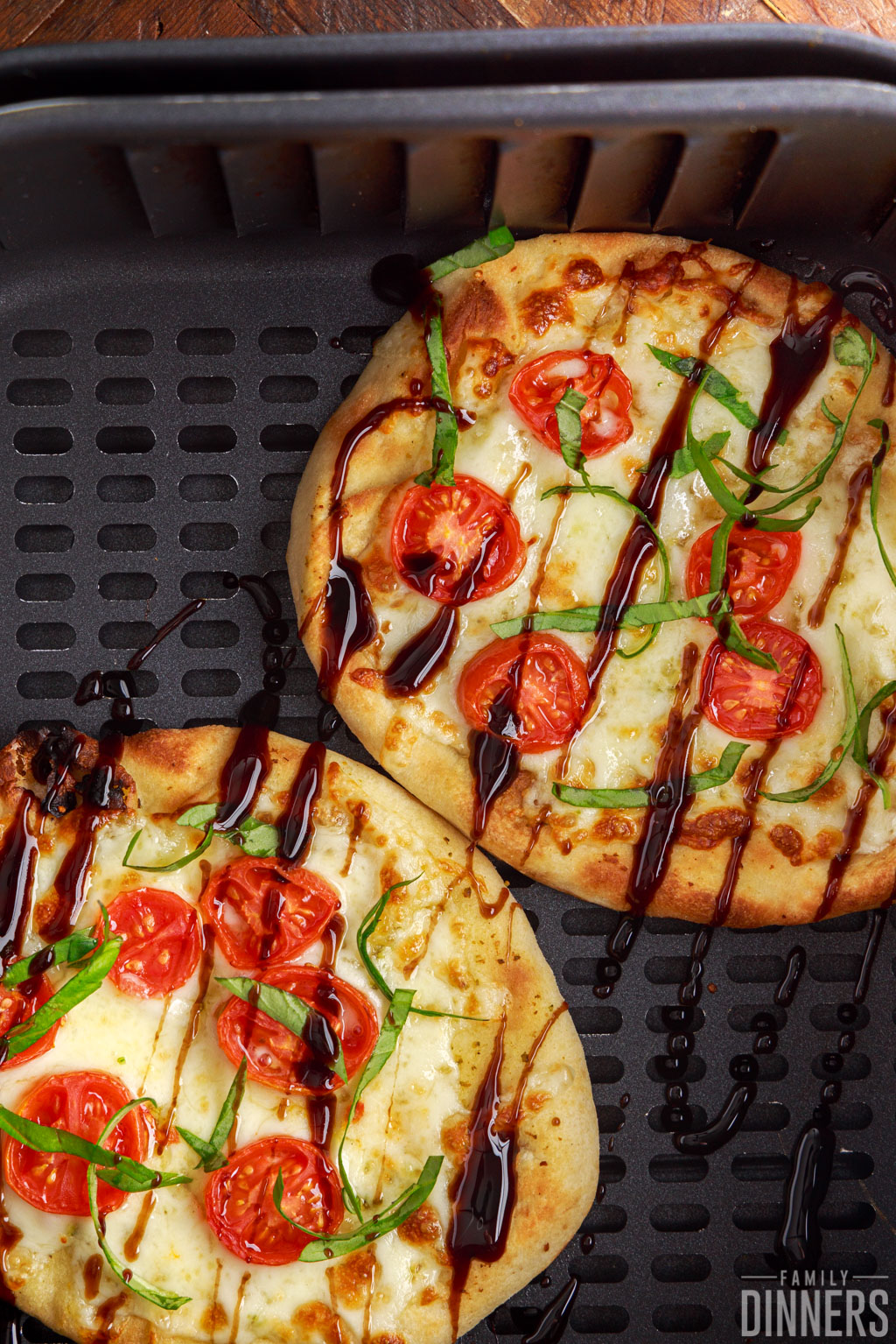 Caprese Naan Pizza in an air fryer basket.