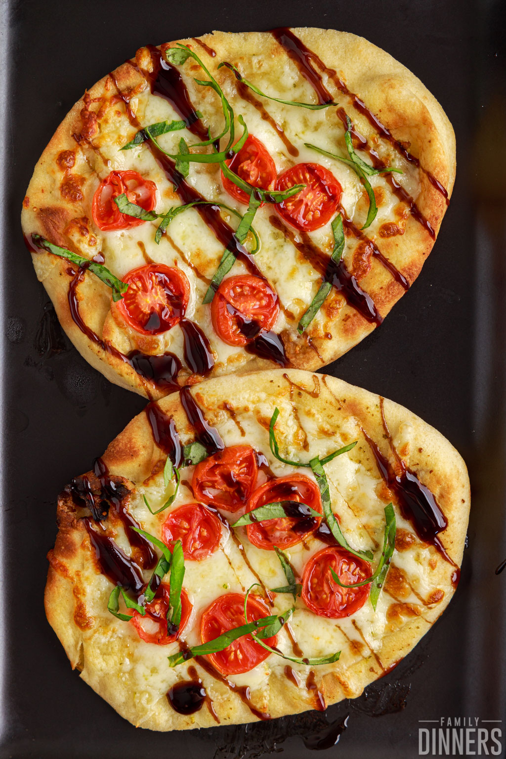Two caprese pizzas on naan bread.