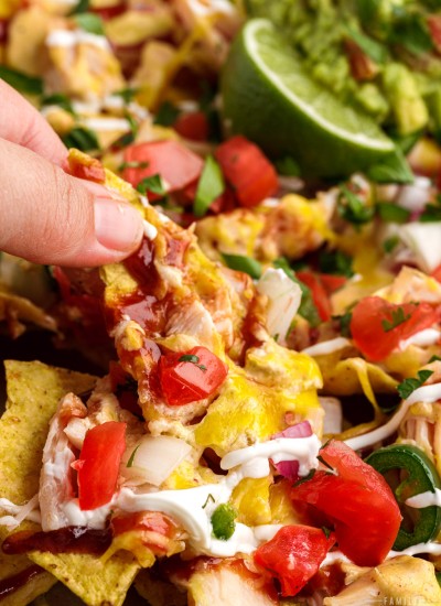 BBQ chicken nachos with chicken, cheese, sour cream, barbecue sauce and lots of toppings.