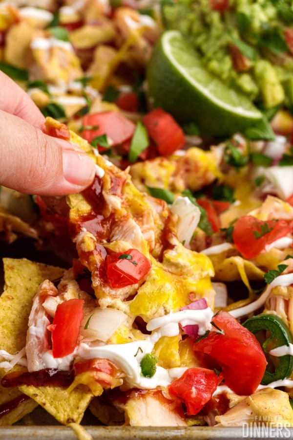 BBQ chicken nachos with chicken, cheese, sour cream, barbecue sauce and lots of toppings.