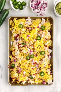Uncooked nachos on a sheet pan.