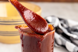 homemade bbq sauce on a wooden spoon.