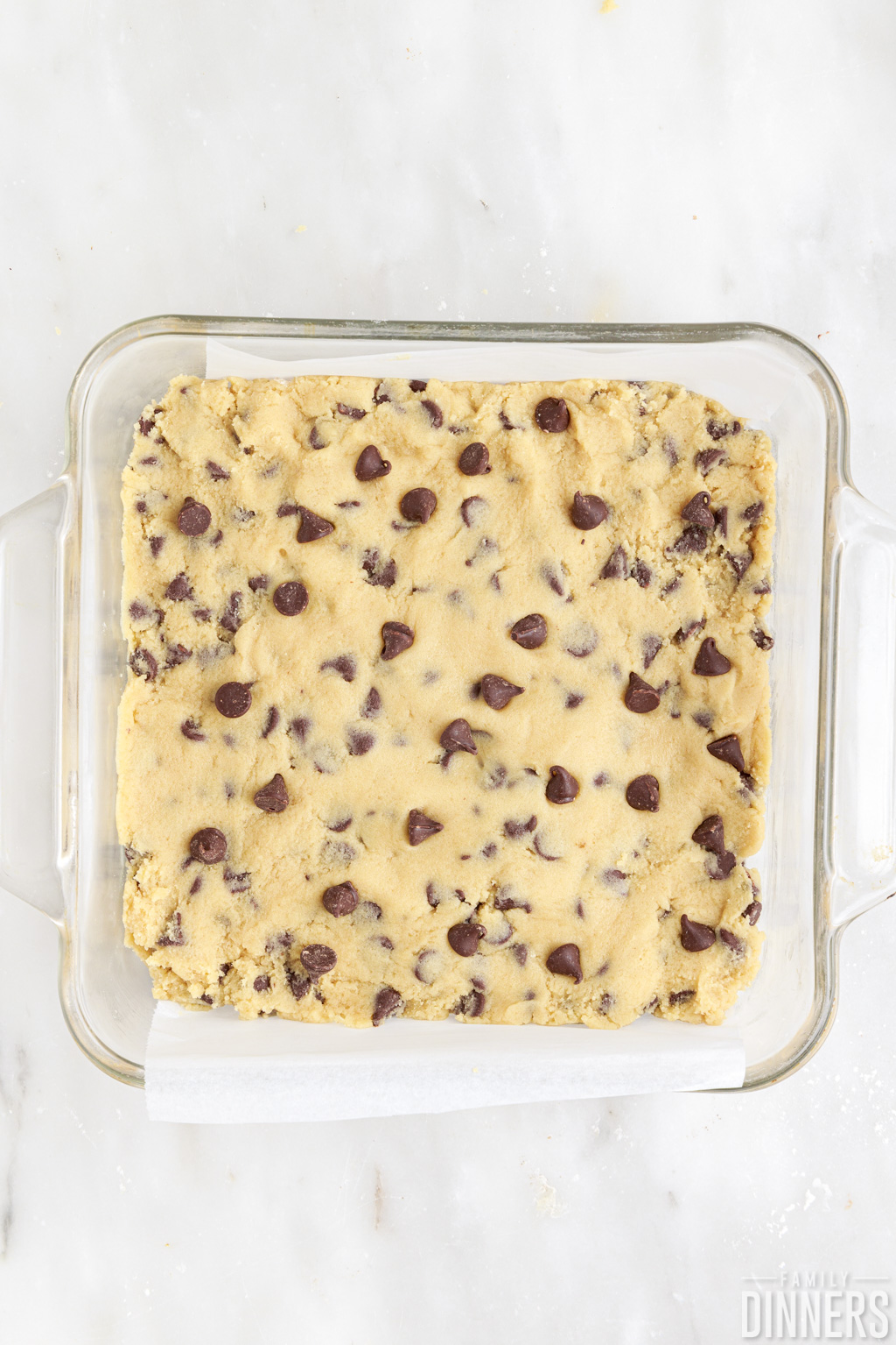 flattened cookie dough in a baking dish.