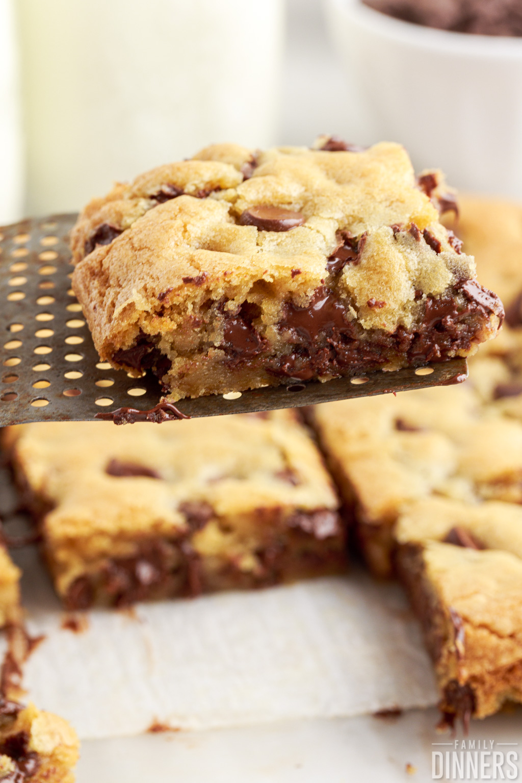 better than toll house chocolate chip cookie bars cut up on a spatula.