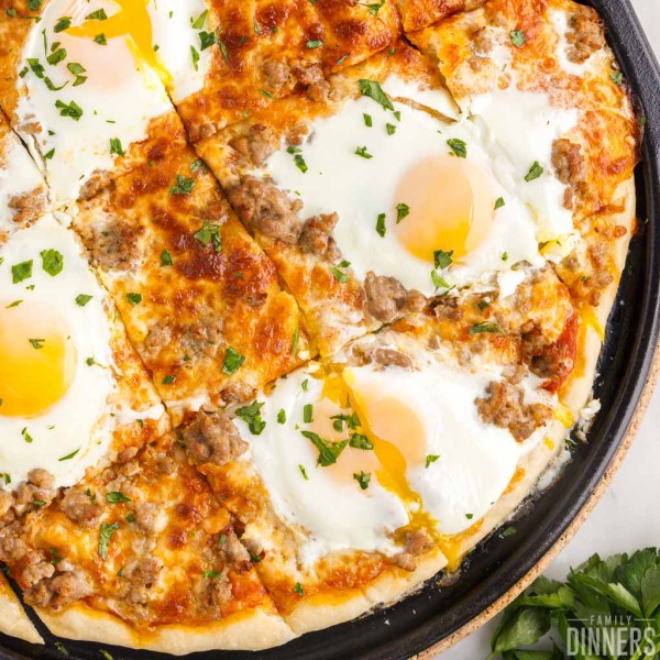Sausage breakfast pizza with egg on top.