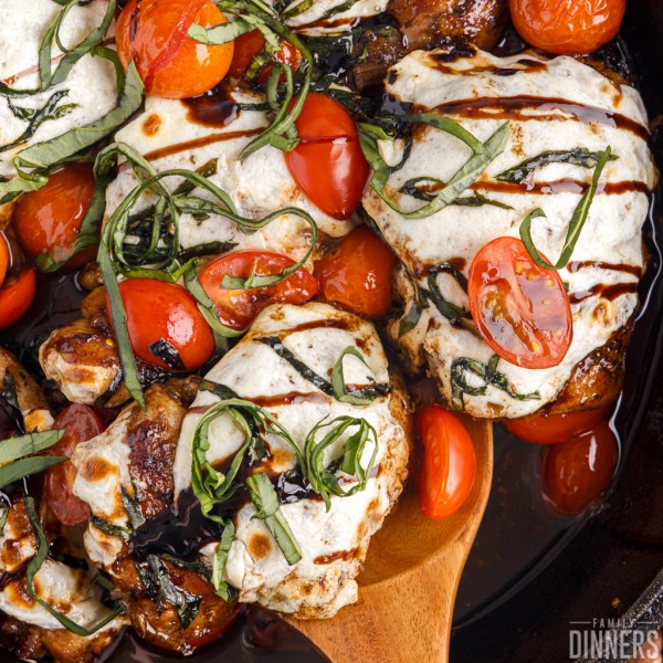 Caprese chicken thighs on a spatula.