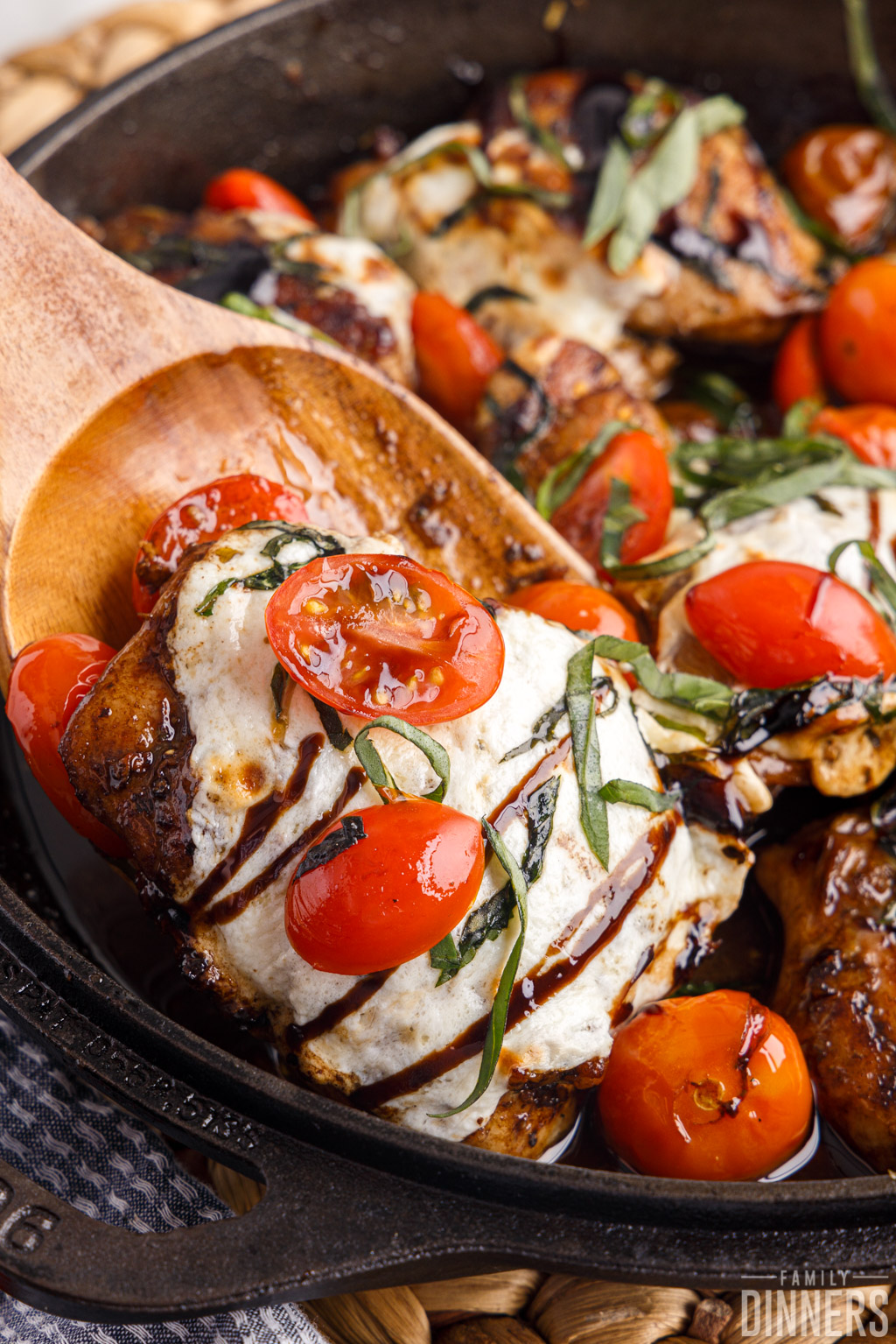 close up of cooked tomato and mozzarella chicken thighs