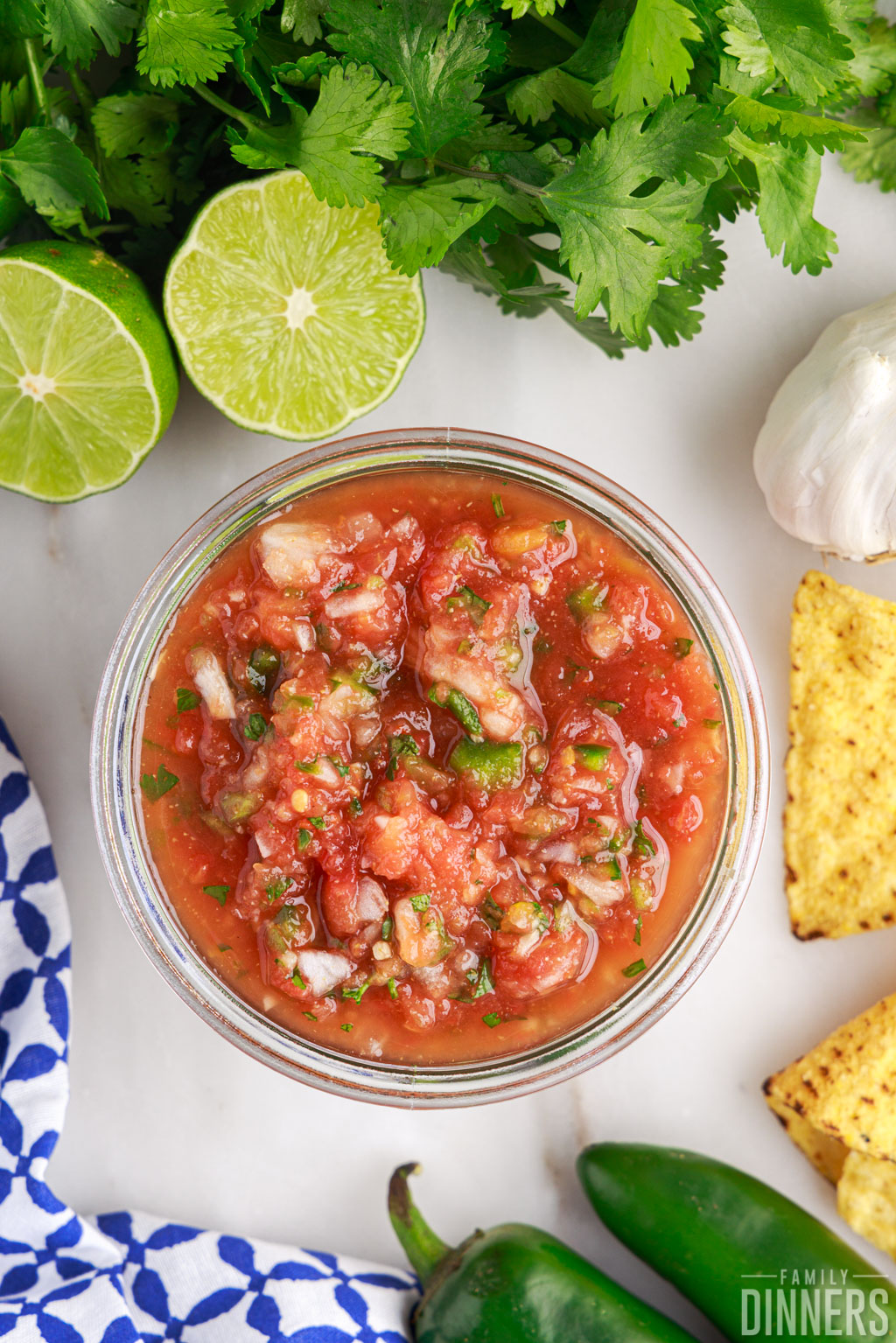 open jar of salsa with canned tomatoes