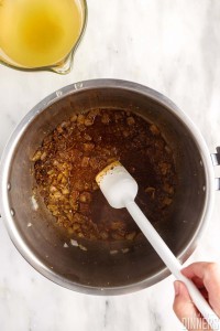 Spatula stirring ingredients in instant pot.