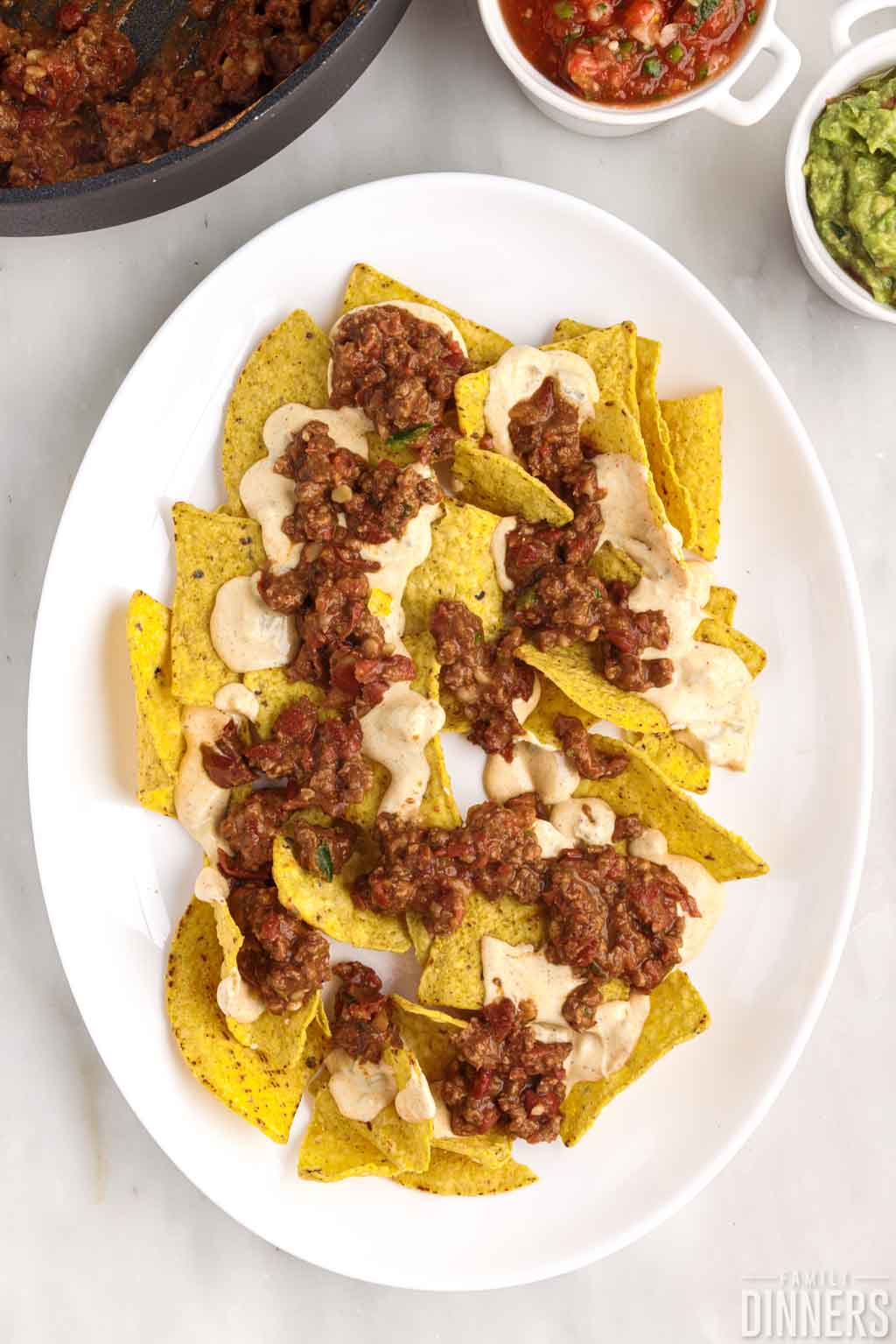 Tortilla chips with beef mixture and cheese.