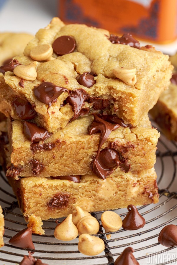 peanut butter cookie bars stacked on top of each other, one with a bite taken out