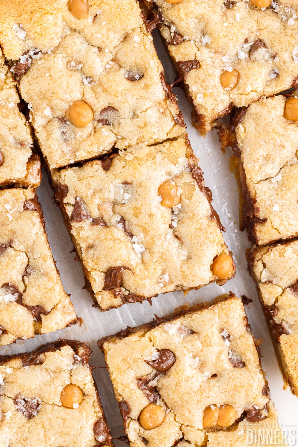 Cut squares of salted caramel chocolate chip cookie bars.