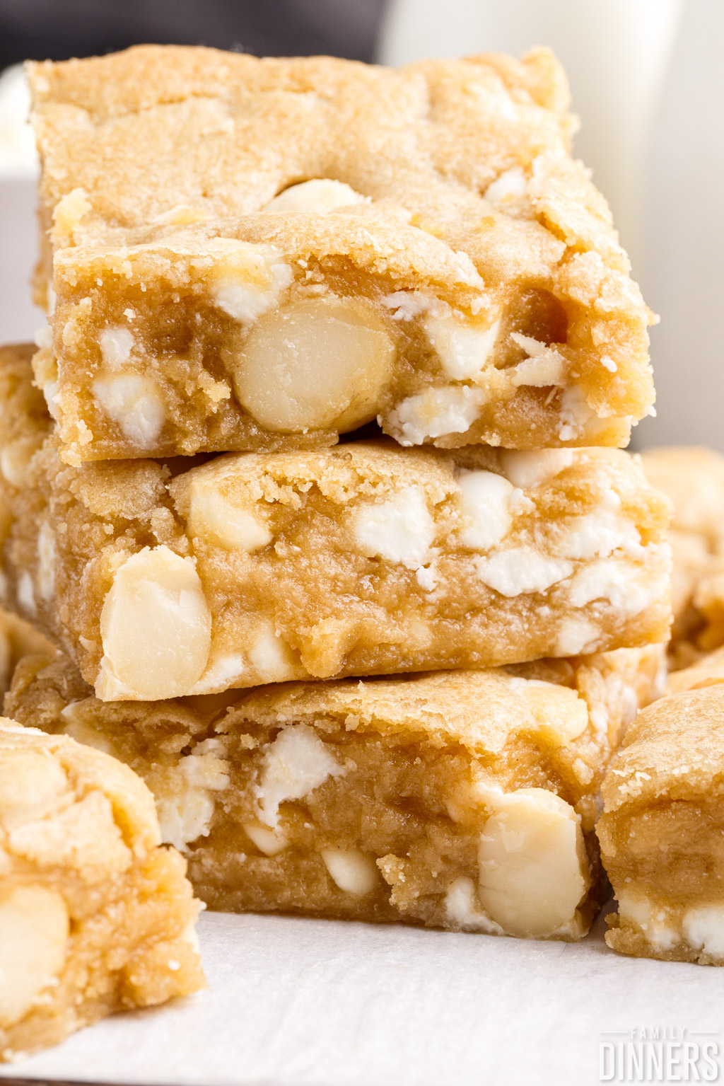 close up of stacked white chocolate macadamia nut cookie bars