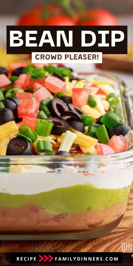 7 layered bean dip in a glass casserole dish. Text: bean dip.