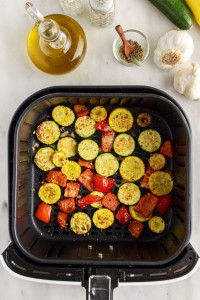 Roasted vegetables in the air fryer basket.