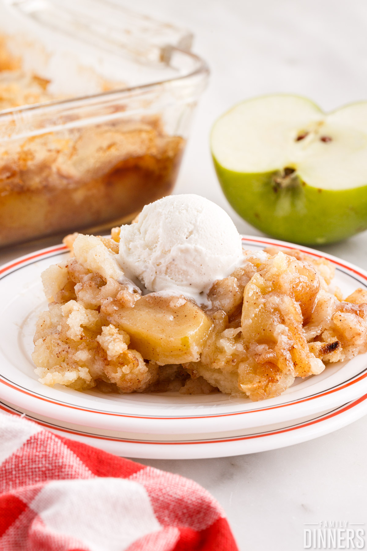 apple crisp on a plate topped with ice cream